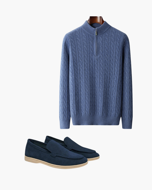 Designer casual outfit set featuring a blue zip-up cable knit sweater and matching navy blue loafers