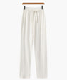 White casual loose fit pants with elastic waistband and drawstring hanging on wooden hanger